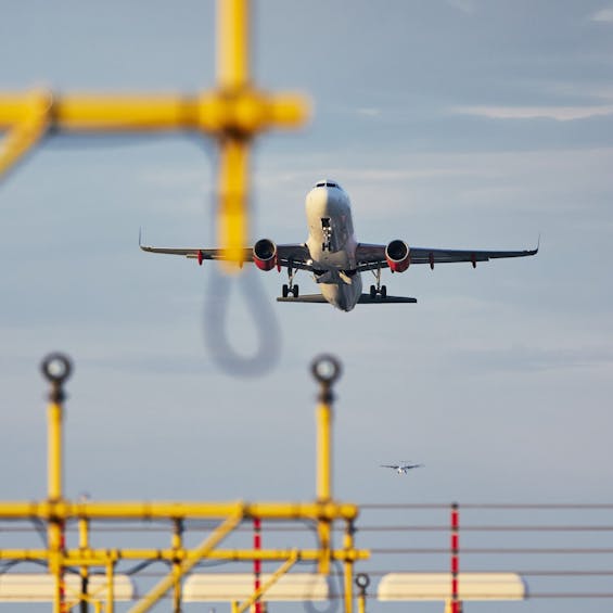 Traffic at the airport. Low angle view of the airplane during take off over landing lights.